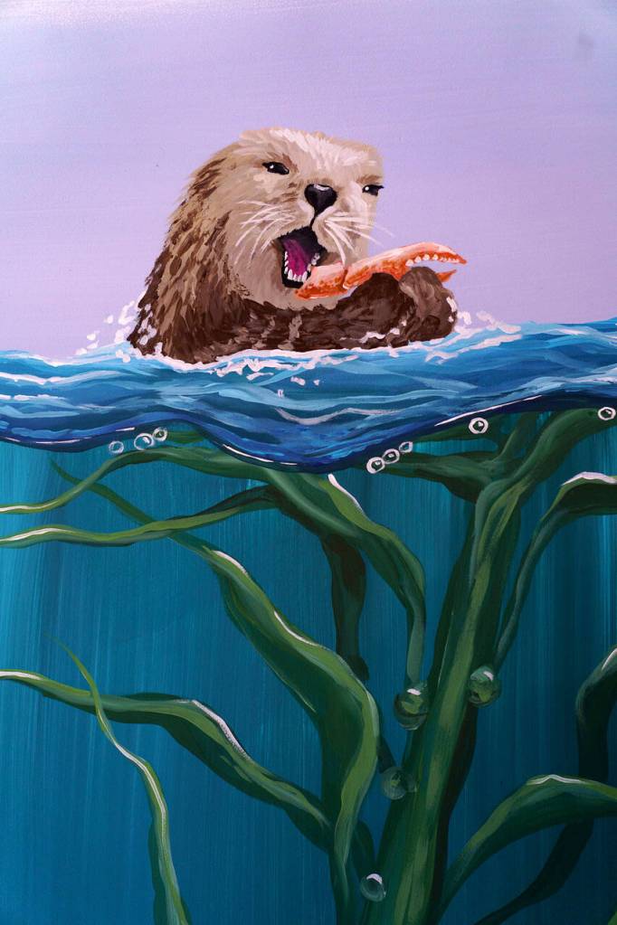 An adorably painted otter munches on a crab leg in the mural.