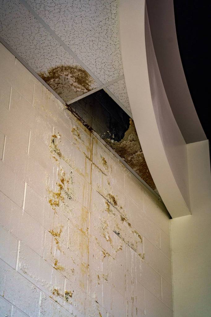 A gaping hole in the ceiling of a room near the auditorium points to excessive water damage. (Photo by David Welton)