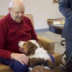 Art Mittlieder, a resident at Harbor Tower Village, spends time with a therapy dog named Dillon.