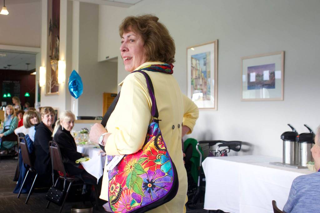 Photo by Rachel Rosen/Whidbey News-Times
Peggy Whitford models a purse in a fashion show that raised money to purchase ambulances for WhidbeyHealth.