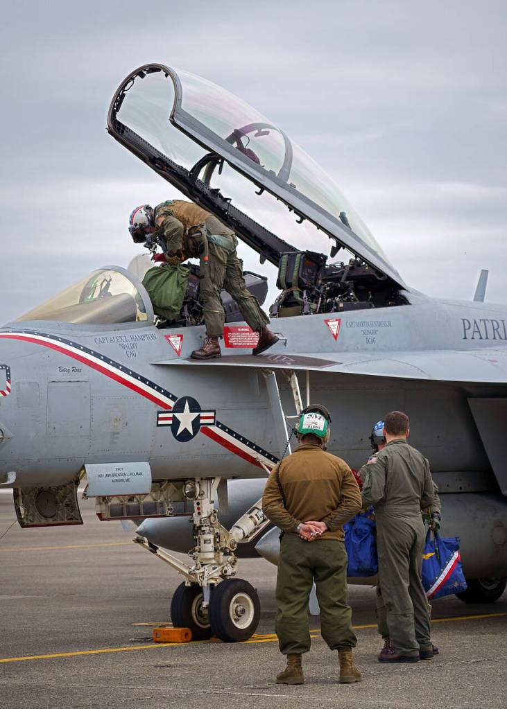 Aircrew with VAQ-140 deplane at Naval Air Station Whidbey Island after returning home from an eight-month deployment aboard aircraft carrier USS George H.W. Bush.