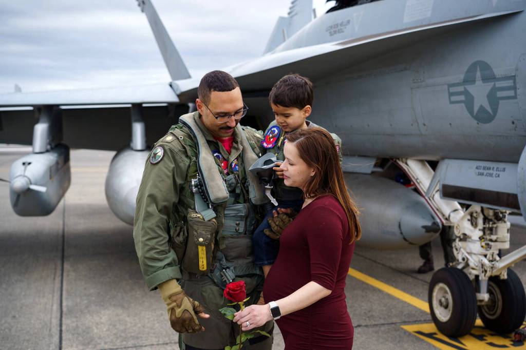 Sarah Heller greets her husband Robert with their son Saturday afternoon.