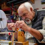 Jon Lyman works on a segment of a fly fishing rod in his workshop. For nearly 25 years, Lyman has built custom bamboo rods that honor of legacy of anglers. (Photo by David Welton)