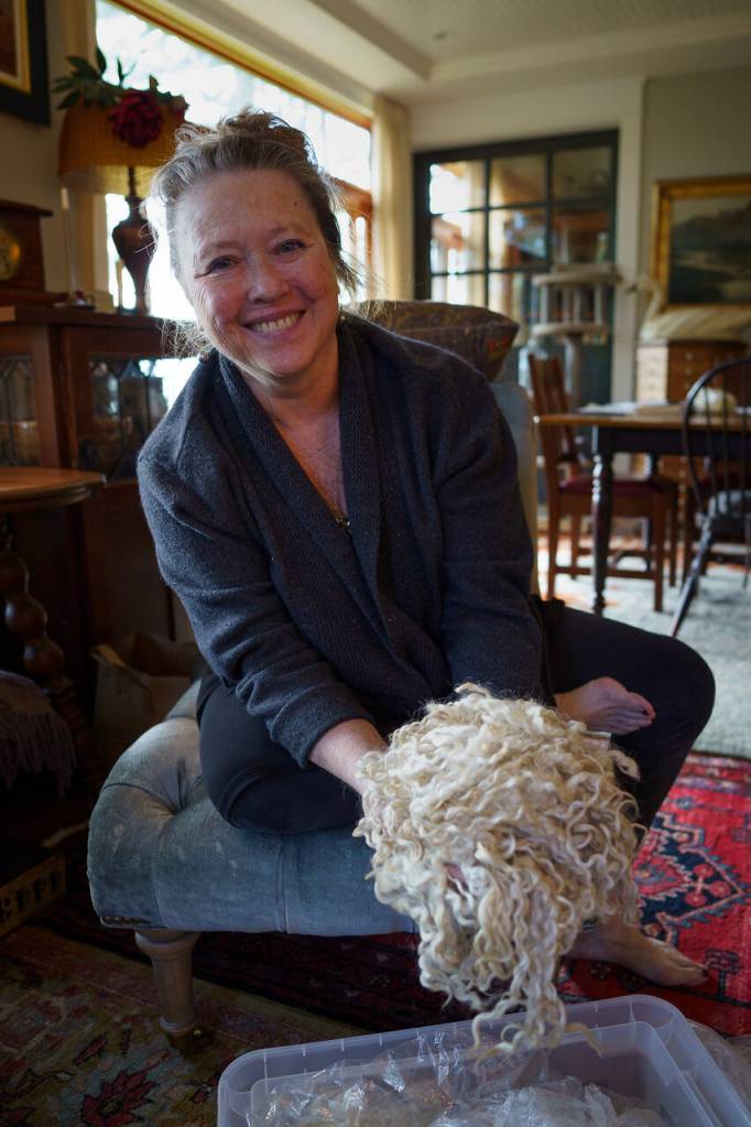 Nan Leaman shows off a Teeswater fleece. (Photo by David Welton)