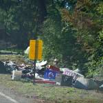 Island County posted a sign warning people living at the Hoffman Road camp that the area is going to be cleaned. (Photo by Rachel Rosen)