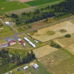 A Google Earth image shows the buildings and the runway at the small airport near Oak Harbor.