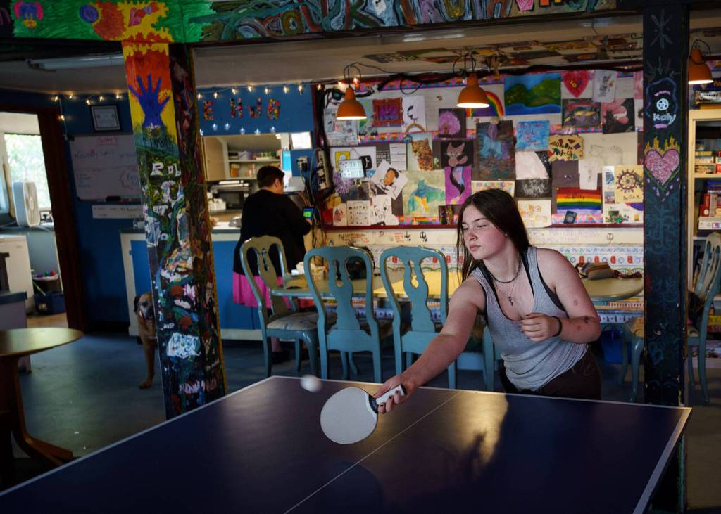 Eighth grader Archer Massa plays a match of ping pong at the HUB. (Photo by David Welton)