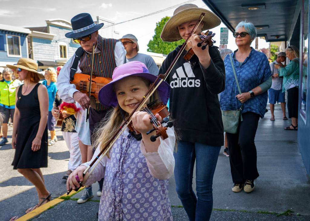 A young student played an instrument. (Photo by David Welton)