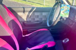 The interior of the “Pork Chop Express". Owner Dave "Bronco" Erickson is seeking to re-home the car for $500, which includes the pictured unicorn air freshener. (Andrea Brown / The Herald)