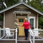 Photos by David Welton
Bon Thayer, THiNC site manager, and Deborah Hedlund, a member of the organizations board, shake hands at the completion of the tiny house project.