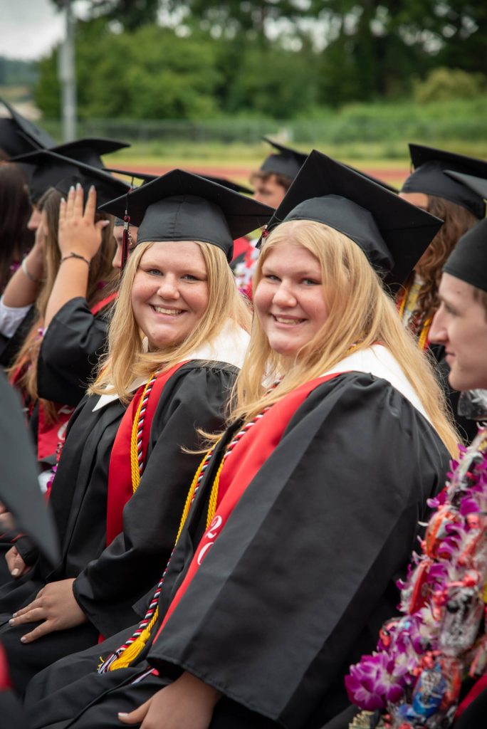 Coupeville graduates Maya and Allie Lucero radiate happiness during the ceremony. (Cynthia Woerner Photography)