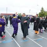 Oak Harbor High School graduates hand out high-fives during the ceremony. (Photo by John Fisken)