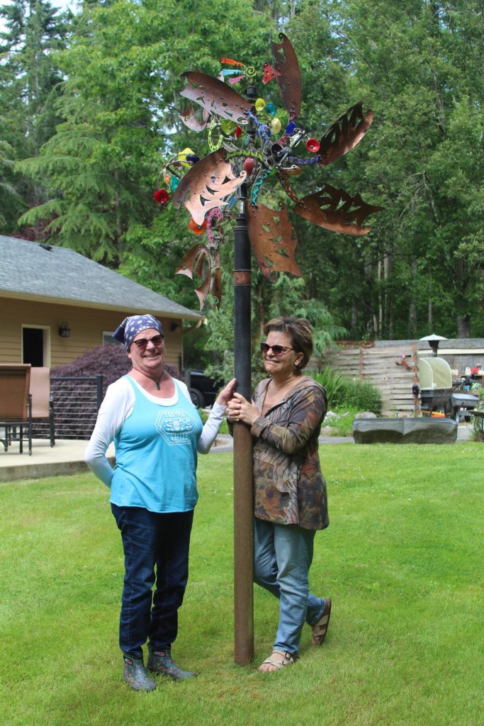 Photo by Karina Andrew/Whidbey News-Times
Therese Kingsbury, left, and Robin Boyle enjoy the kinetic artwork that can be found in Kingsburys garden.