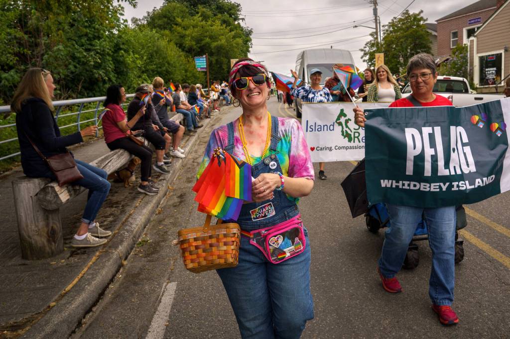 Fe Mischo handed out rainbow flags during the Langley Pride Parade. (Photo by David Welton)
