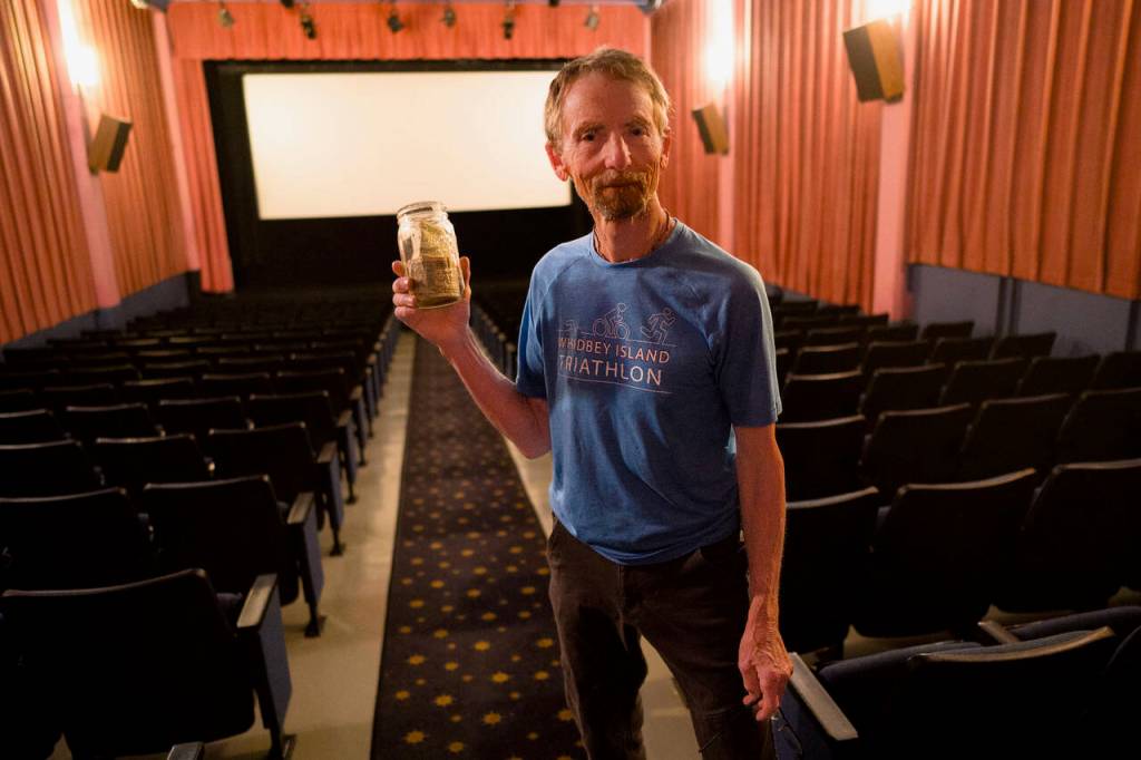 Photo by David Welton
Blake Willeford holds up the Magic Change Jar, which turns one dollar into seven for South Whidbey nonprofit organizations.