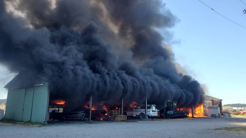 Smoke billows out of the multipurpose farm building. (Photo by Luisa Loi)