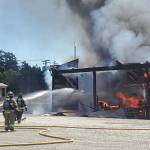 Firefighters attack fire that destroyed the large metal building. (Photo by Luisa Loi)