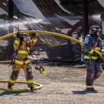 Firefighters with Central Whidbey Island Fire and Rescue fight a fire that destroyed a farm building. (Photo by David Welton)