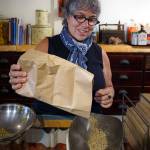 Karyn Schwartz measures out some herbs for a remedy. (Photo by David Welton)
