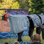 A mime spots a 15-feet-long puppet whale from the bow of his ship. (Photo by Jo Arlow)