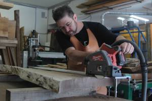 Photo by Karina Andrew/Whidbey News-Times
Ty Balascio of Coastal Woodworks cuts of a piece of wood in his Oak Harbor shop Aug. 23.
