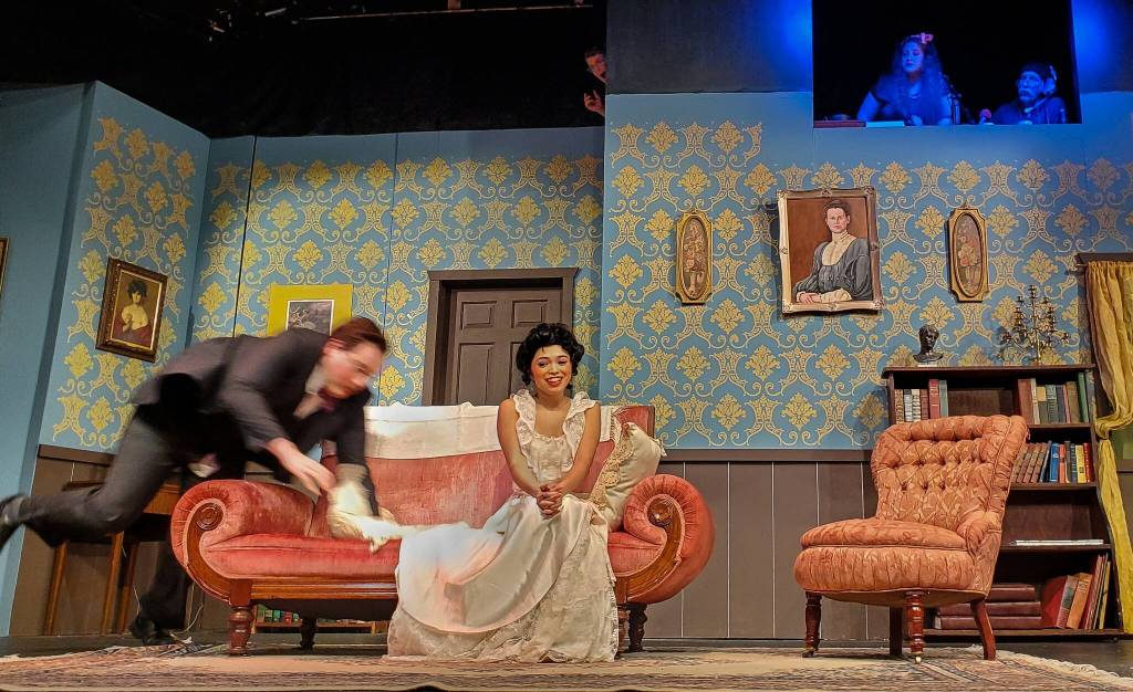 Billy Carew/Stephen Sellers (played by Wesley Moran) falls during the premiere of Murder Most Foul as staff watches horrified from behind the scenes. (Photo by Luisa Loi/Whidbey News-Times)