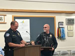 Photo provided
Oak Harbor Police Officer Mel Lolmaugh receives the Emergency Treatment Award at a city council meeting Sept. 5.