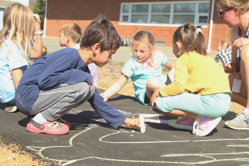 Photo by Karina Andrew/Whidbey News-Times
First grader Ian Kerner helps chalk the walk Sept. 15 at Hillcrest Elementary School.