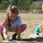Photo by Karina Andrew/Whidbey News-Times
First grader Madilynn Davenport helps chalk the walk Sept. 15 at Hillcrest Elementary School.