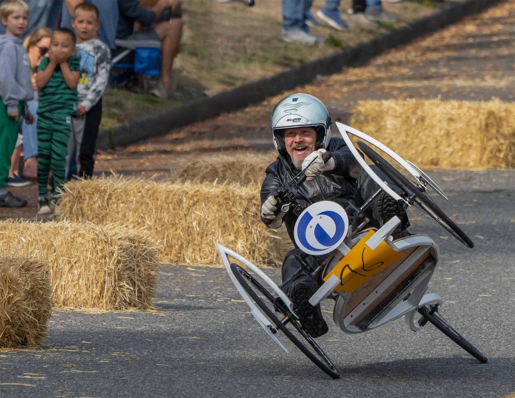 Photo by Mike Holtby
Matt Chambers was living on the edge during the Soup Box Derby in Langley Sept. 17. He crashed twice in his wheeled contraption but was uninjured. Many brightly colored and costumed participants zoomed down First Street hill in a variety of gravity-powered cars during the quirky event, which returned for the first time in four years.