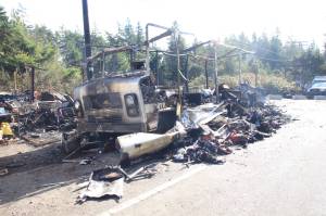 An RV was destroyed in a fire Sunday at a roadside homeless encampment. (Photo by Luisa Loi / Whidbey News-Times)