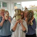 Photo by David Welton
Peggy Larmore, Karen Abel and Kristine McInvaille pose with some of the masks displayed at the Reveal/Conceal exhibit.