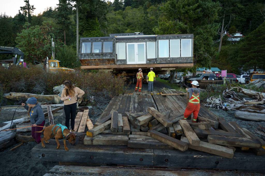 Moving the house from the barge to a truck is a slow-moving process. (Photo by David Welton)