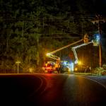 A Puget Sound Energy crew temporarily shut off power and moved lines to make way for the house. (Photo by David Welton)