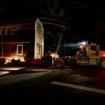 A house is trucked through the dark back roads of South Whidbey. (Photo by David Welton)