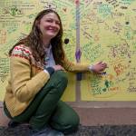 Langley Library Manager Kaley Costello points out her favorite notes on a wall people signed during the librarys centennial celebration earlier this month. (Photo by David Welton)