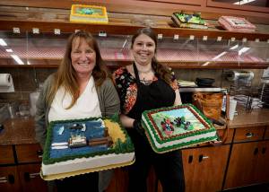 Photo by David Welton
Pia Stewart and Jennifer Holmes showcase some of their most creative cake displays, which include a Whidbey theme with a ferry dock made out of Kit Kats and Mario Kart characters.