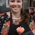Photo by David Welton
Jennifer Holmes pipes her flowers onto a wooden dowel before transferring them to the cake she is decorating.