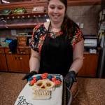 Photo by David Welton
Jennifer Holmes pipes a colorful flower crown for the La Catrina skull on her cake that has a Dia De Los Muertos theme.