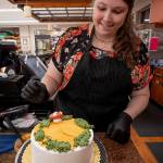 Photo by David Welton
Jennifer Holmes places red-capped mushrooms made of buttercream frosting on her cake. Coconut mixed with green frosting gives the perfect mossy appearance.
