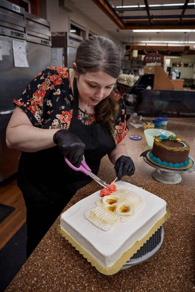 Photo by David Welton
Jennifer Holmes pipes a colorful flower crown for the La Catrina skull on her cake that has a Dia De Los Muertos theme.