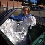 Joan Green of rePurpose sifts through the dumpster at the South Whidbey Community Center in search of reusable materials. (File photo by David Welton)