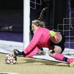 Oak Harbor High School goalkeeper Lauren Marrs blocks a shot Oct. 26 during a play-in game against Arlington. The game went to penalty kicks where Oak Harbor won. (Photo by John Fisken)