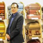 Stucky poses in front of a colorful display of casket corners. (Photo by Luisa Loi/Whidbey News-Times)