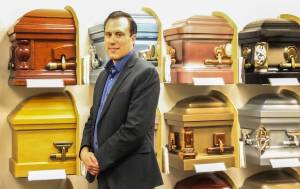 Photo by Luisa Loi/Whidbey News-Times
Stucky poses in front of a colorful display of casket corners.