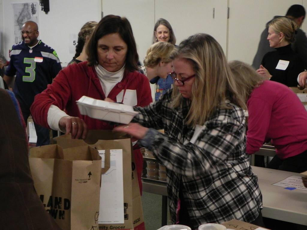 Volunteers Helen Price Johnson, left, and Kim Kramer pack meals in 2014. (Photo provided)