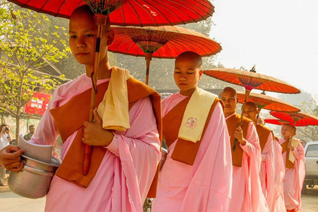 Nuns in Myanmar on their way to collect rice from townspeople. (Photo by Mike Holtby)