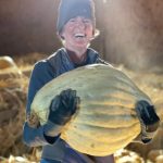 Corrie Chamberlin, Alix Roos sister, holds a 44-pound sugar Hubbard squash. (Photo provided)