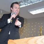 Master of Ceremonies Bryan Stucky points to some of his future customers. Stucky was awarded Best Businessperson of the Year and his business, Wallin-Stucky Funeral Home, won Best Business of the Year. (Photo by Megan Yerton)