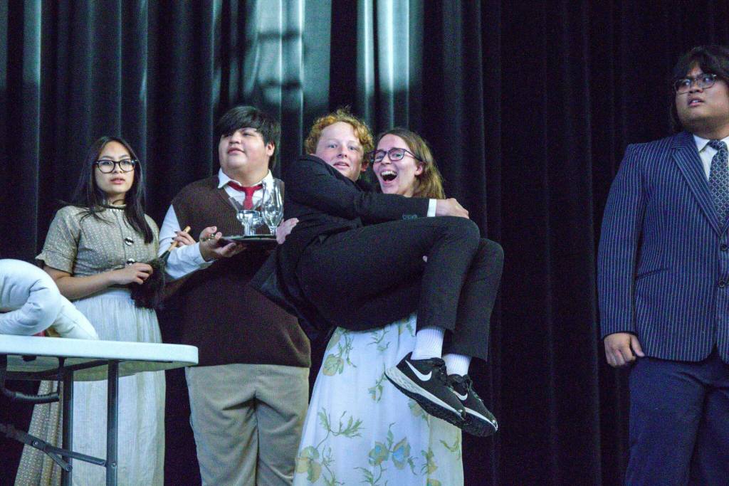 In the foreground, Savannah Dickinson holds Logan Hendricks while rehearsing a scene from No Clue, as Alyza Doctolero, Brian Goodman and Cyrus Amor stand in the background. (Photo by Luisa Loi)